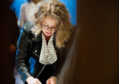 Woman signing a document at The Common Ground of Energy Transformation event