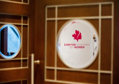 Mirror showing a reflection of the Canada Powered by Women logo