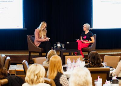 Women sitting in chairs on stage at The Common Ground of Energy Transformation event