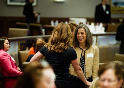 Two women talking and smiling at the The Common Ground of Energy Transformation event