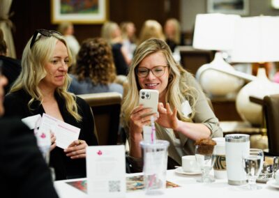 Woman taking a photo from her iPhone at The Common Ground of Energy Transformation event