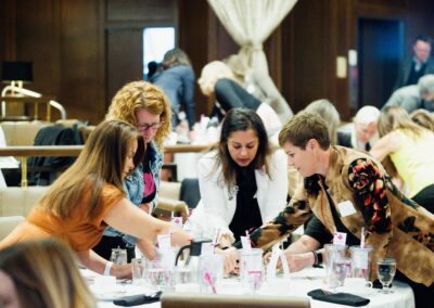 Four women intently solving a puzzle at The Common Ground of Energy Transformation event