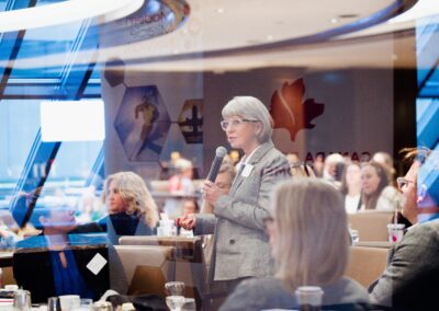 Women giving a speech from her table at The Common Ground of Energy Transformation event